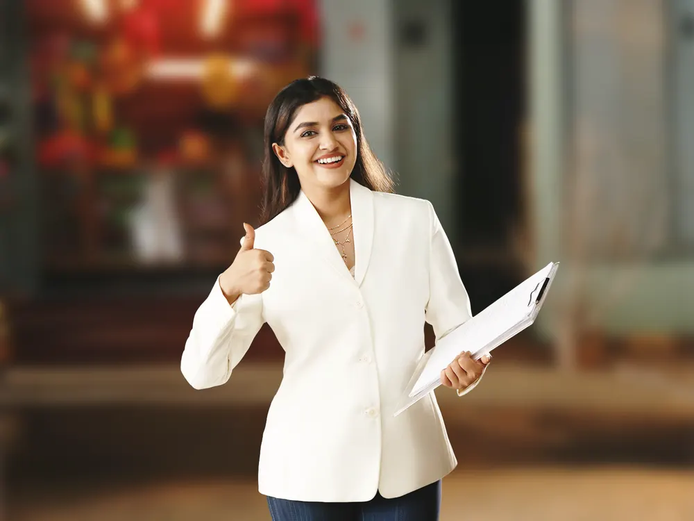 Woman holding a clipboard giving a thumbs-up